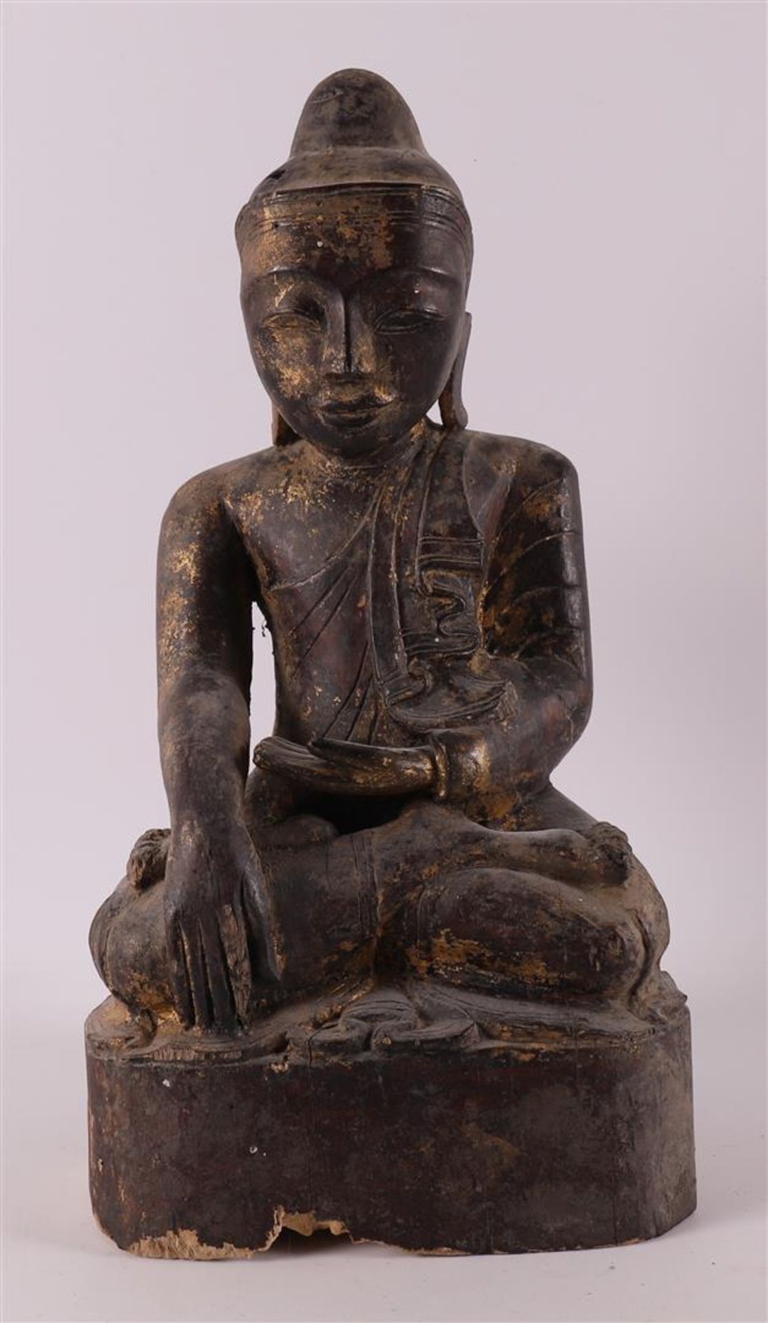 A carved wooden Buddha in lotus position with traces of gilding, Burma,
