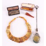 A lot of miscellaneous items, including an amber necklace, cigar pipe with gold 