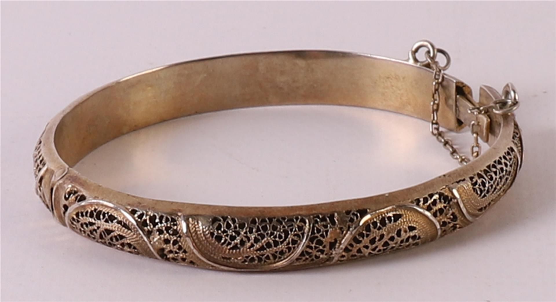A gold-plated silver stiff bracelet with filigree decor