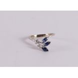An 18 kt gold ring with 3 marquise cut blue sapphires and a diamond