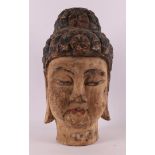 A carved wooden head of a Thai goddess, 19th/20th century.