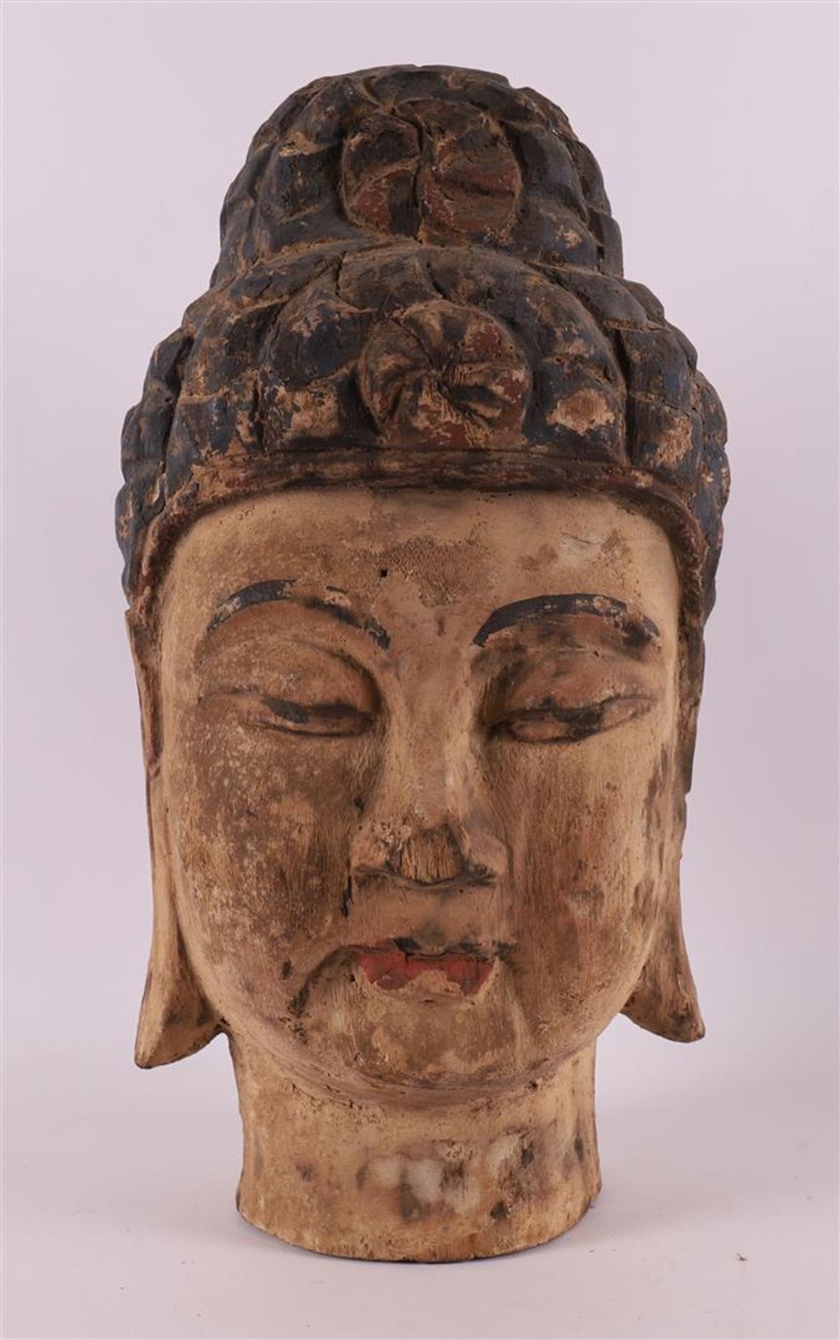 A carved wooden head of a Thai goddess, 19th/20th century.