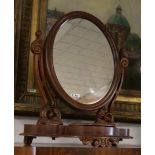 An oval mahogany rotating table top mirror, 19th century.