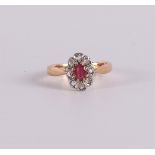 An 18 kt gold entourage ring with an oval facet cut ruby