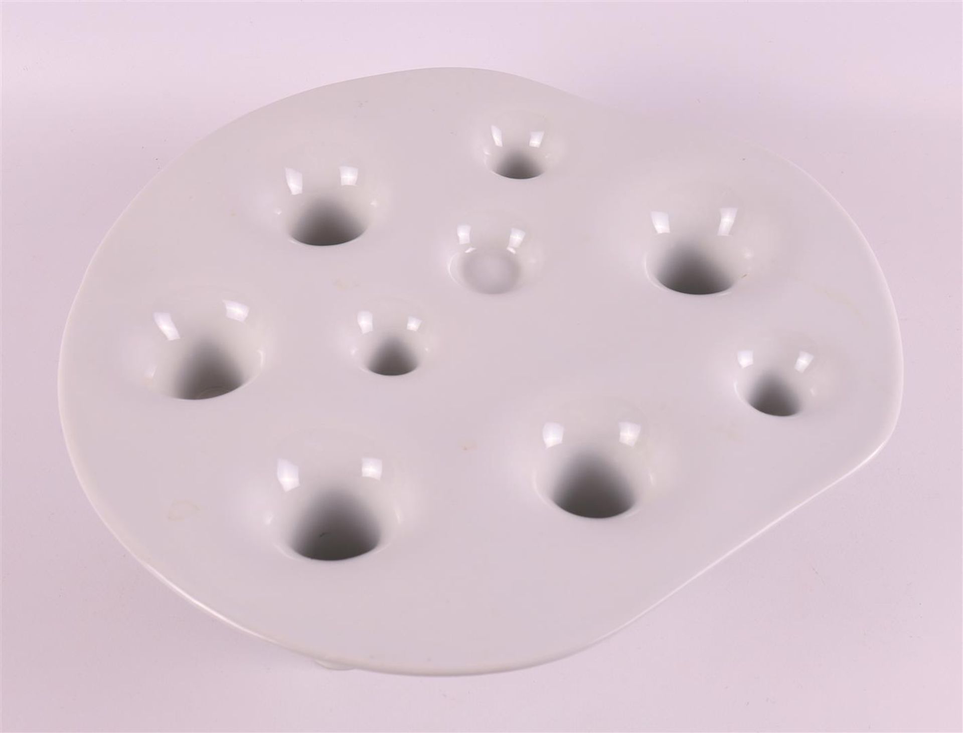A white porcelain fruit bowl 'fruit and fire', design: Willem Noyons.