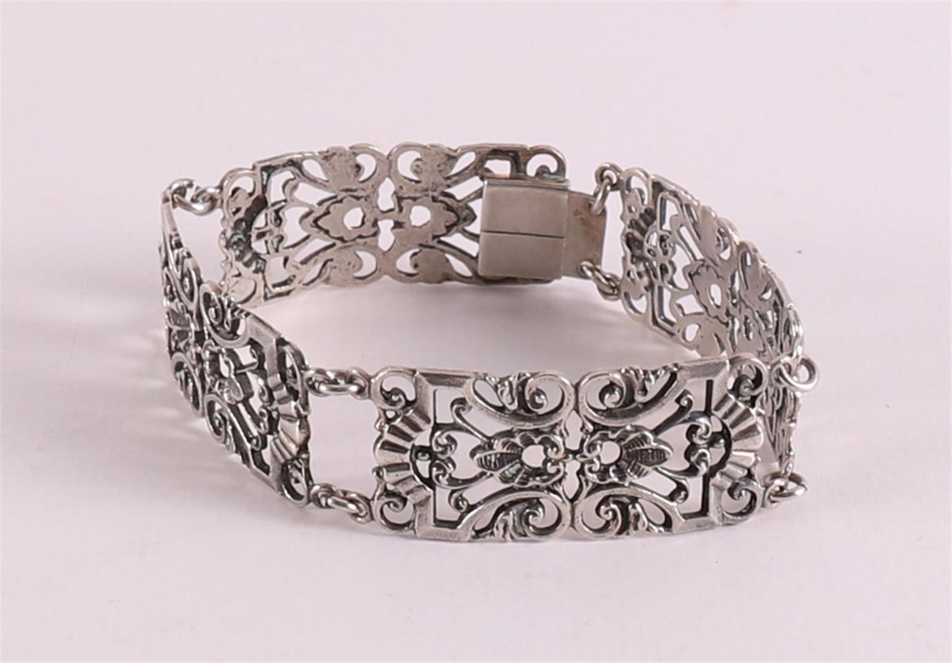 An ajourned second grade 835/1000 silver link bracelet.