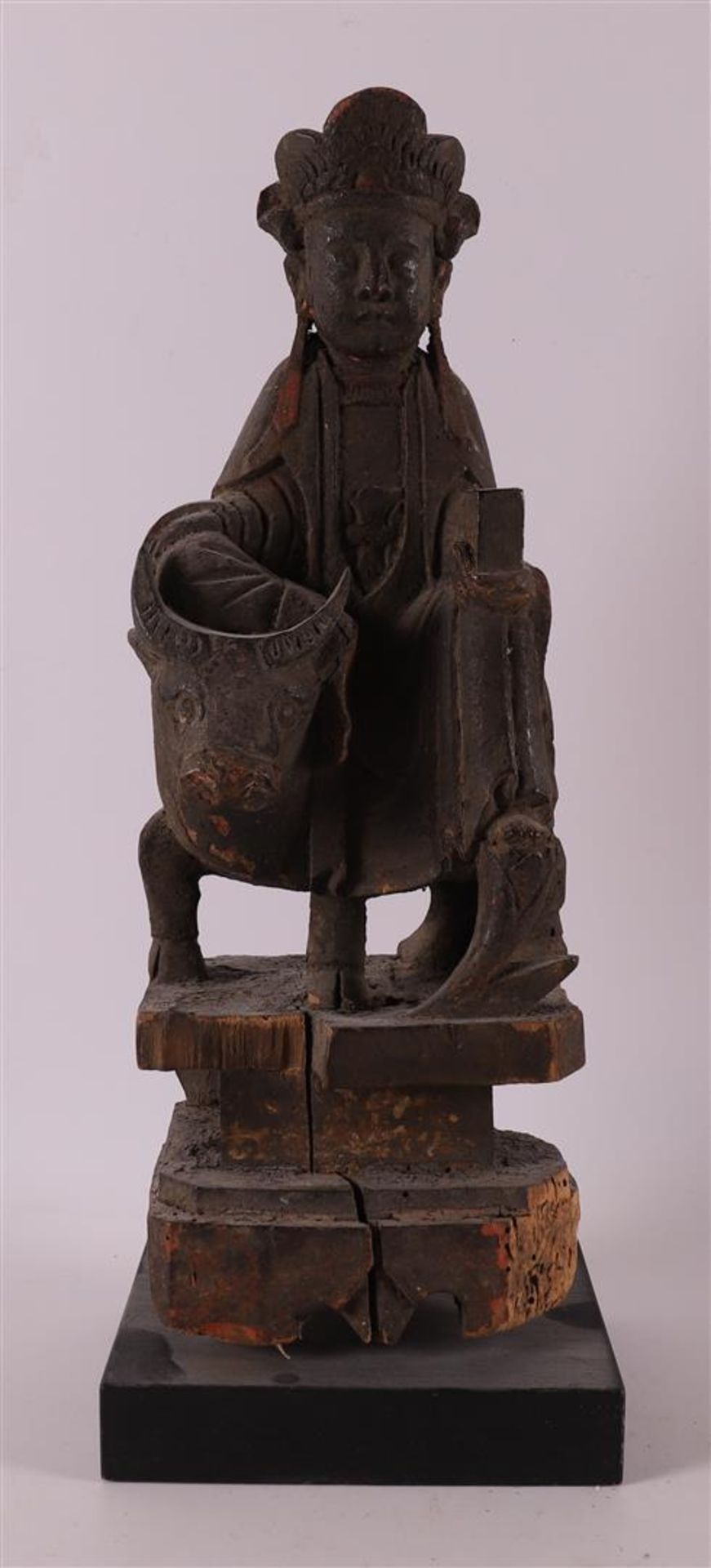 A wooden Kwanyin on an ox with traces of polychromy, China, Qing dynasty