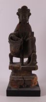 A wooden Kwanyin on an ox with traces of polychromy, China, Qing dynasty