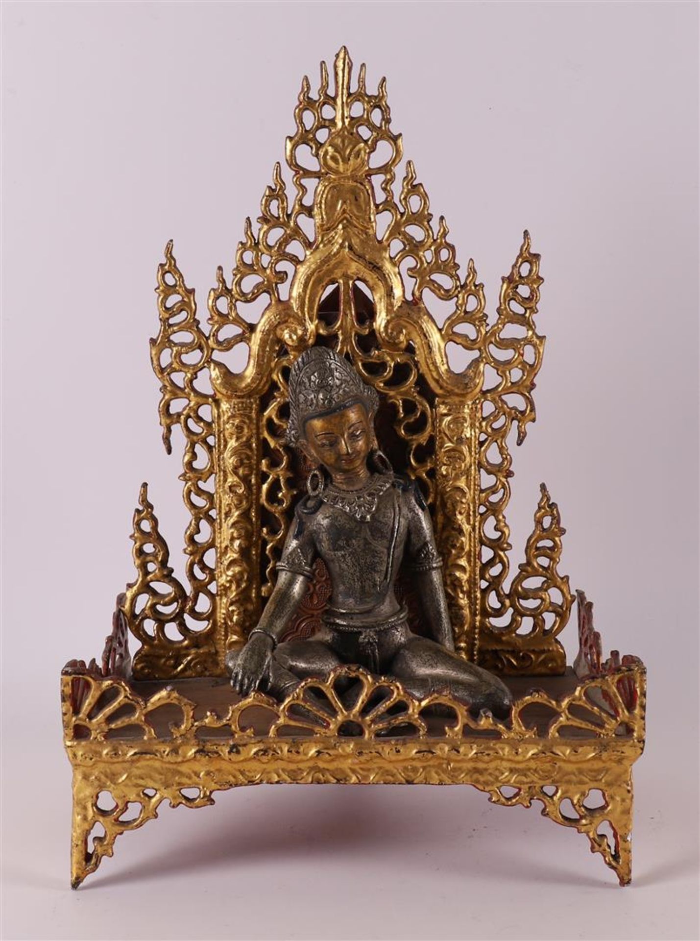 A silver-plated bronze Buddha on a loose gilded throne, India, 19th/20th century
