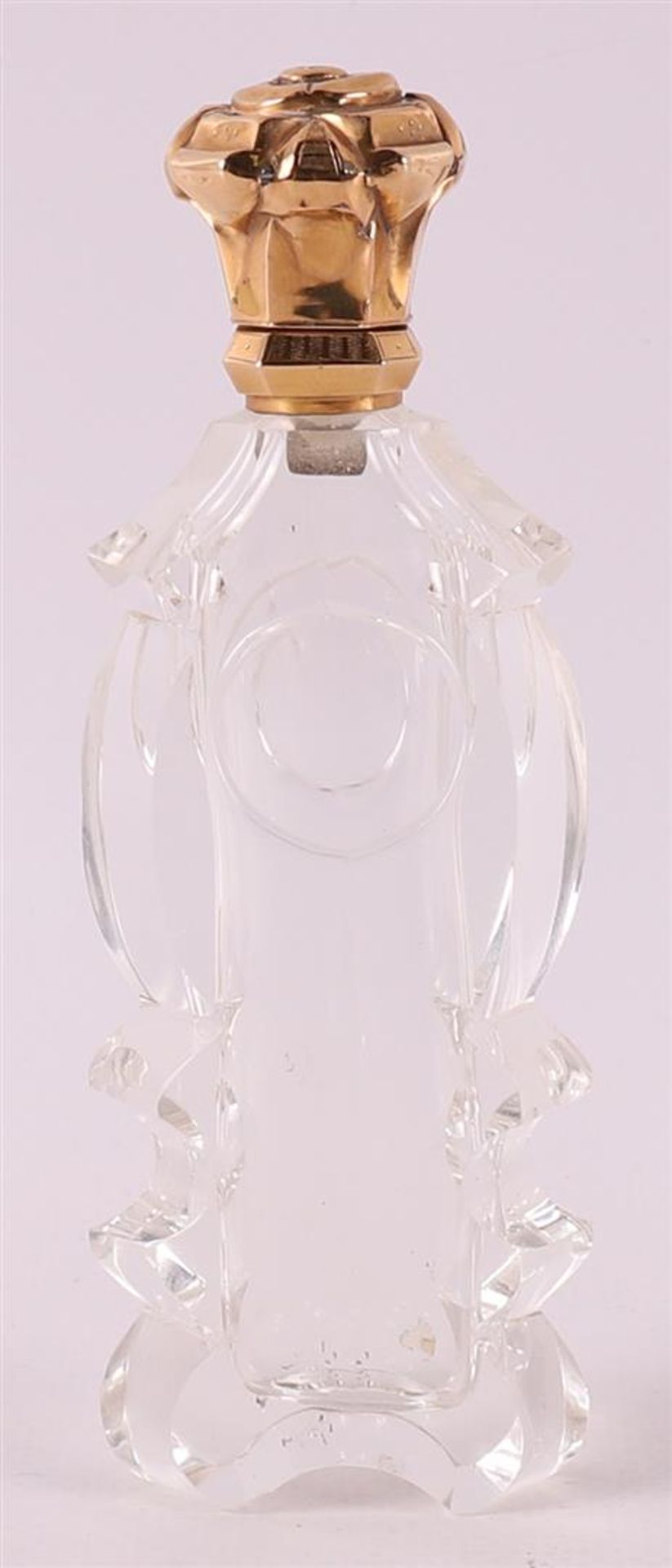 A clear crystal odor flask with gold lid and frame, 19th century.