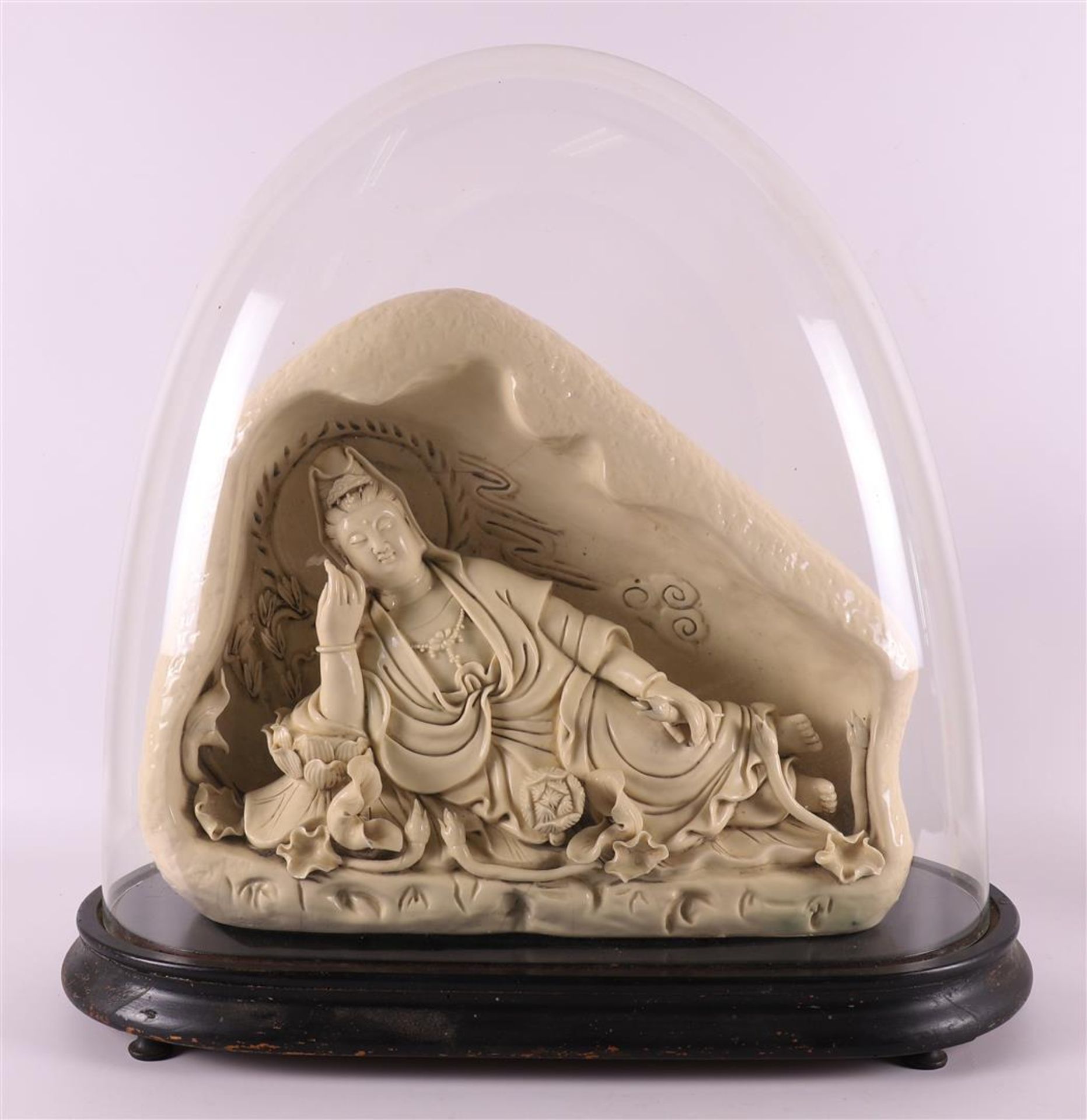 A Dehua porcelain blank de chine lying Kwan-yin on lotus crown, China