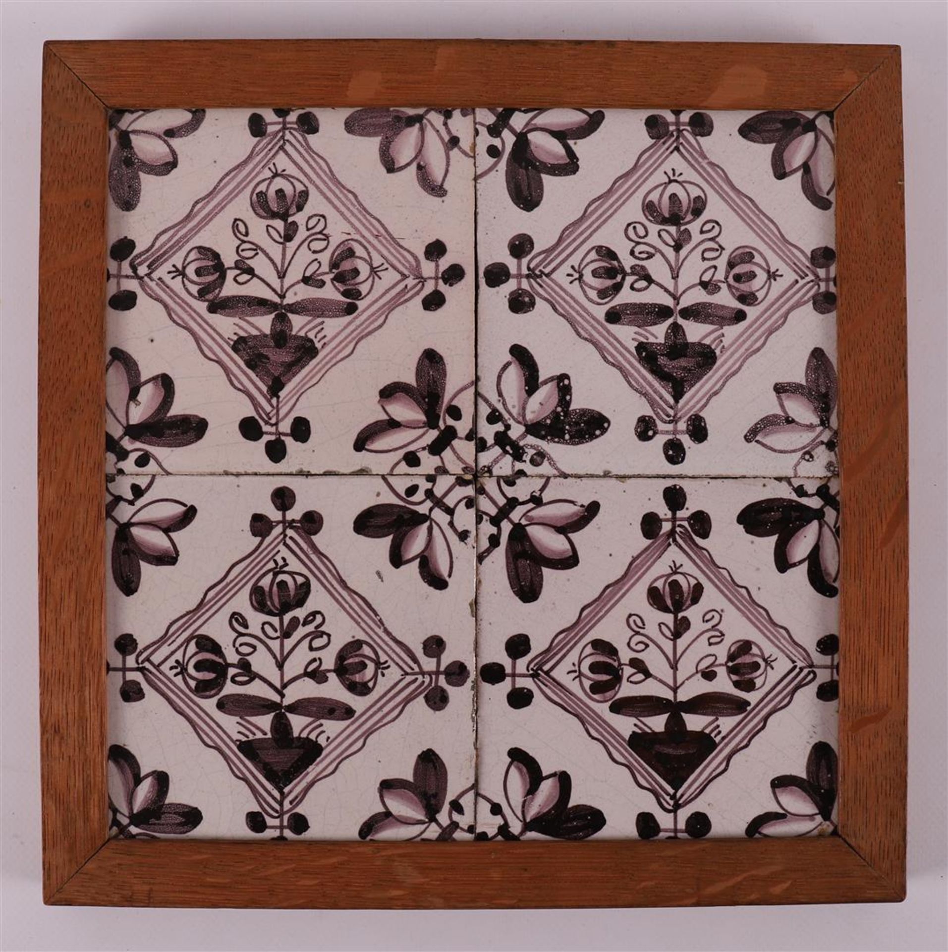 A four-step tile tableau of manganese-colored flower tiles, 18th century.