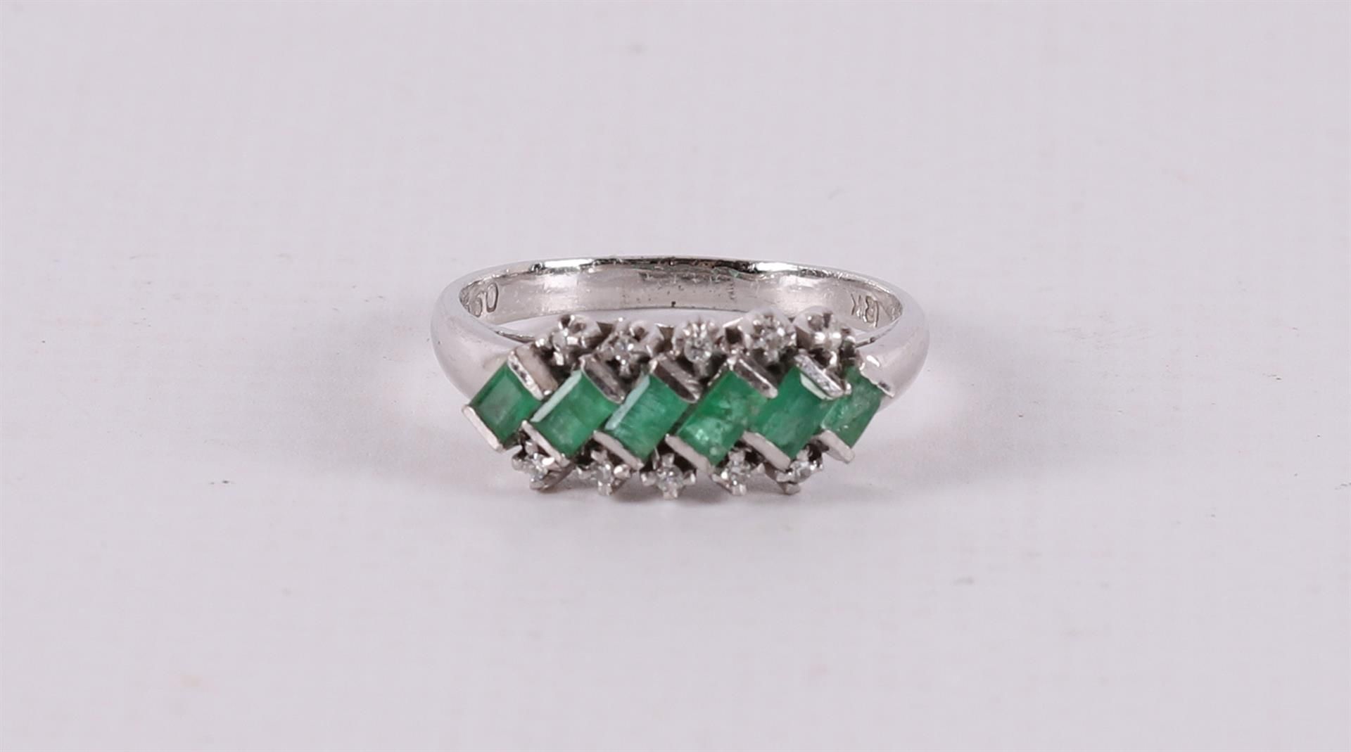 An 18 kt white gold Art Deco ring with 6 cut emeralds and 8 diamonds.