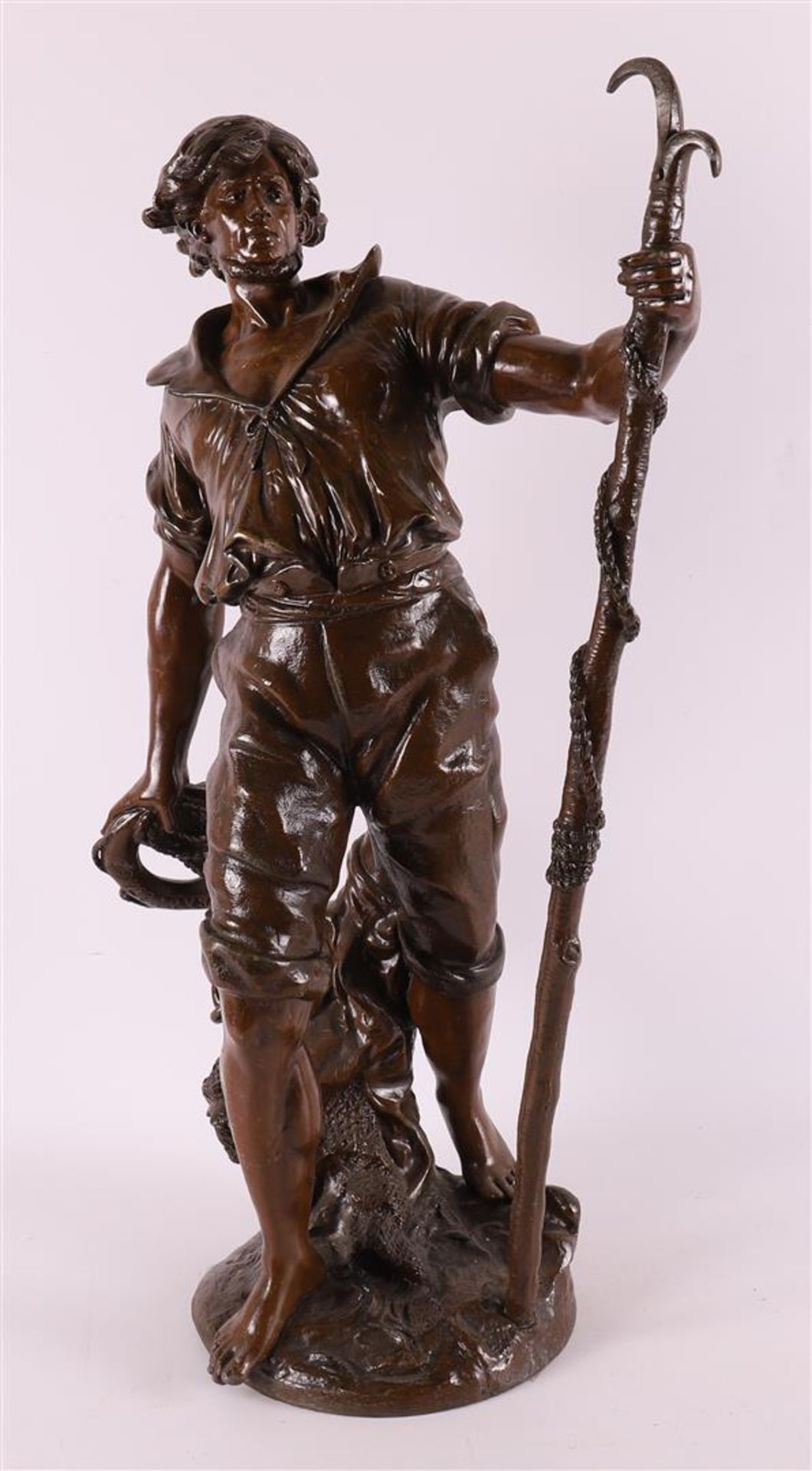 A brown patinated white metal 'samac' sculpture of a fisherman, France,