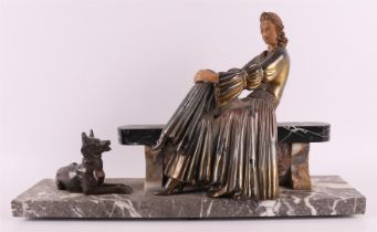 A white metal Art Deco sculpture of a lady on a bench, France, ca. 1920.