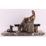 A white metal Art Deco sculpture of a lady on a bench, France, ca. 1920.