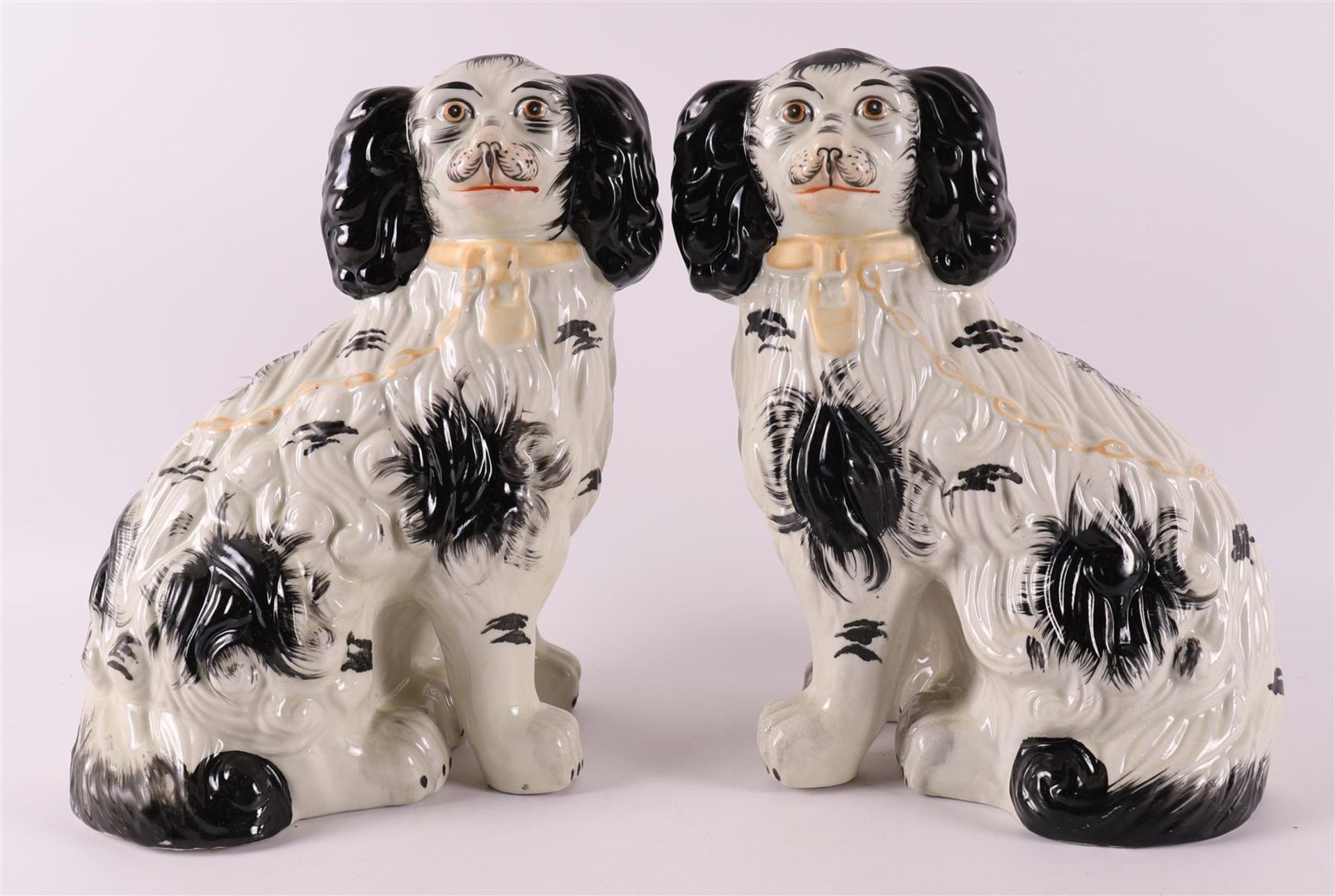 A pair of black and white earthenware dogs, England, Staffordshire, 19th century