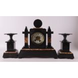 A three-piece black marble mantel clock, late 19th century.
