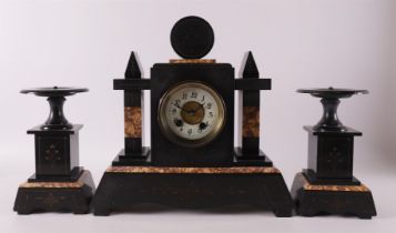 A three-piece black marble mantel clock, late 19th century.