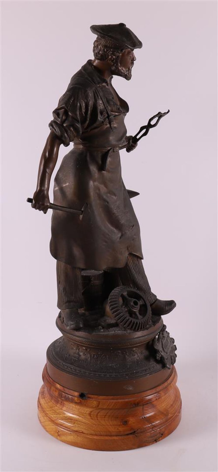 A white metal 'samac' sculpture of a blacksmith, around 1900. - Image 2 of 5