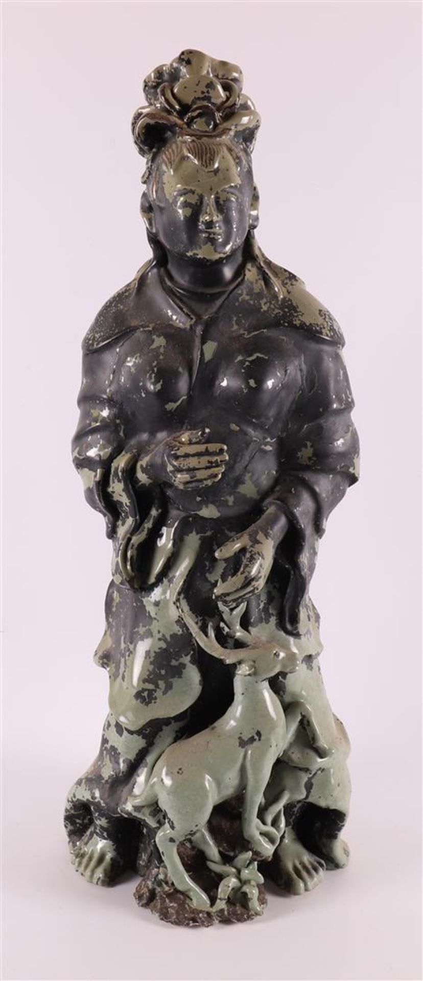 A green glazed porcelain immortal, China, Qing dynasty, 19th century