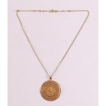 An 18 carat 750/1000 gold filigree pendant on a 14 carat 585/1000 gold necklace.