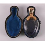 A clear crystal odor flask with gold lid and frame, around 1900