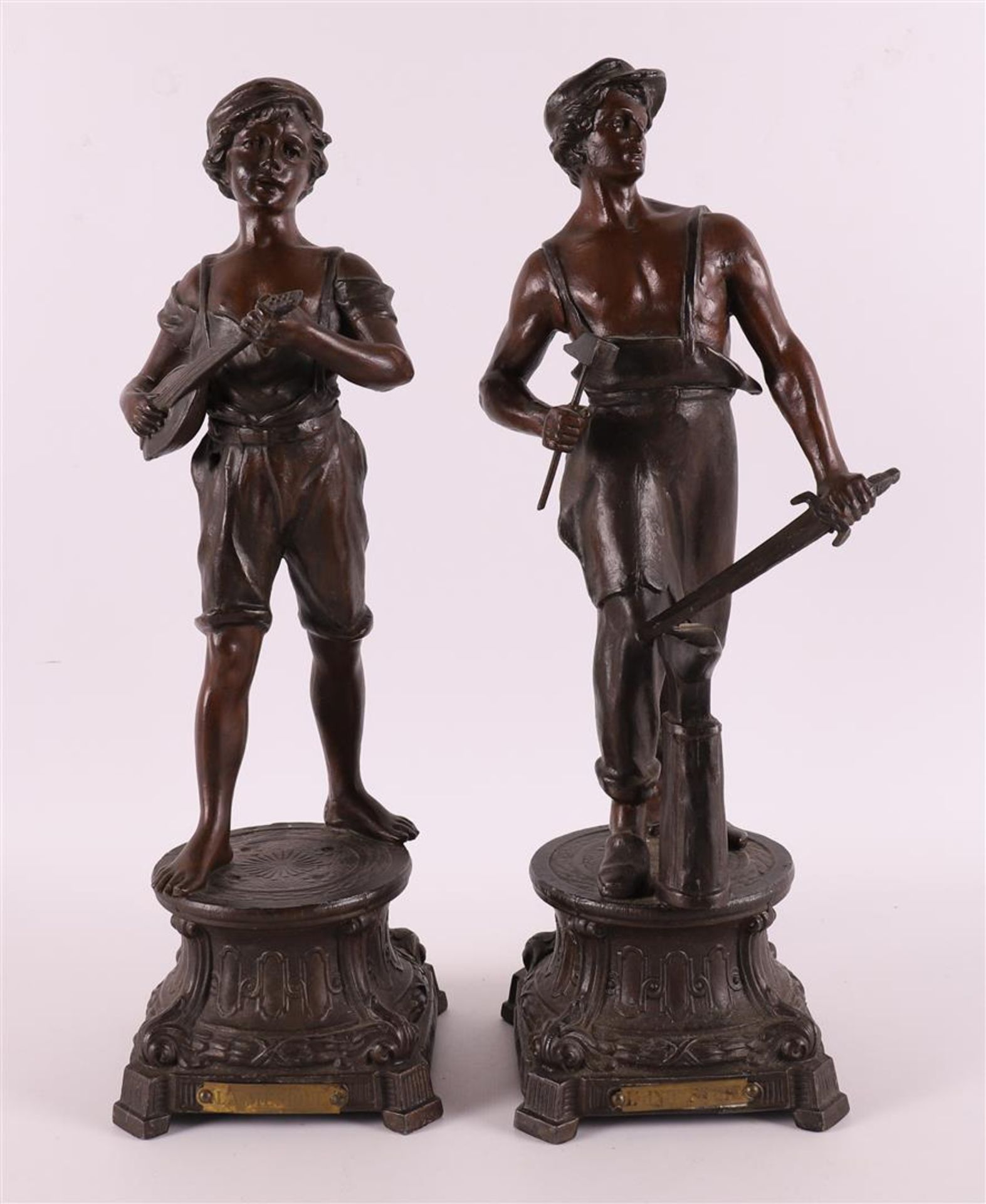 A set of brown patinated white metal 'samac' statues of a lute player and blacks