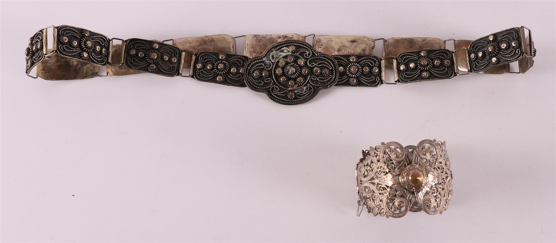 A white metal so-called Indian bridal belt, with decoration of buttons and threa