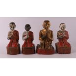 Four carved wooden Burmese Buddhist monks, 19th/20th century.