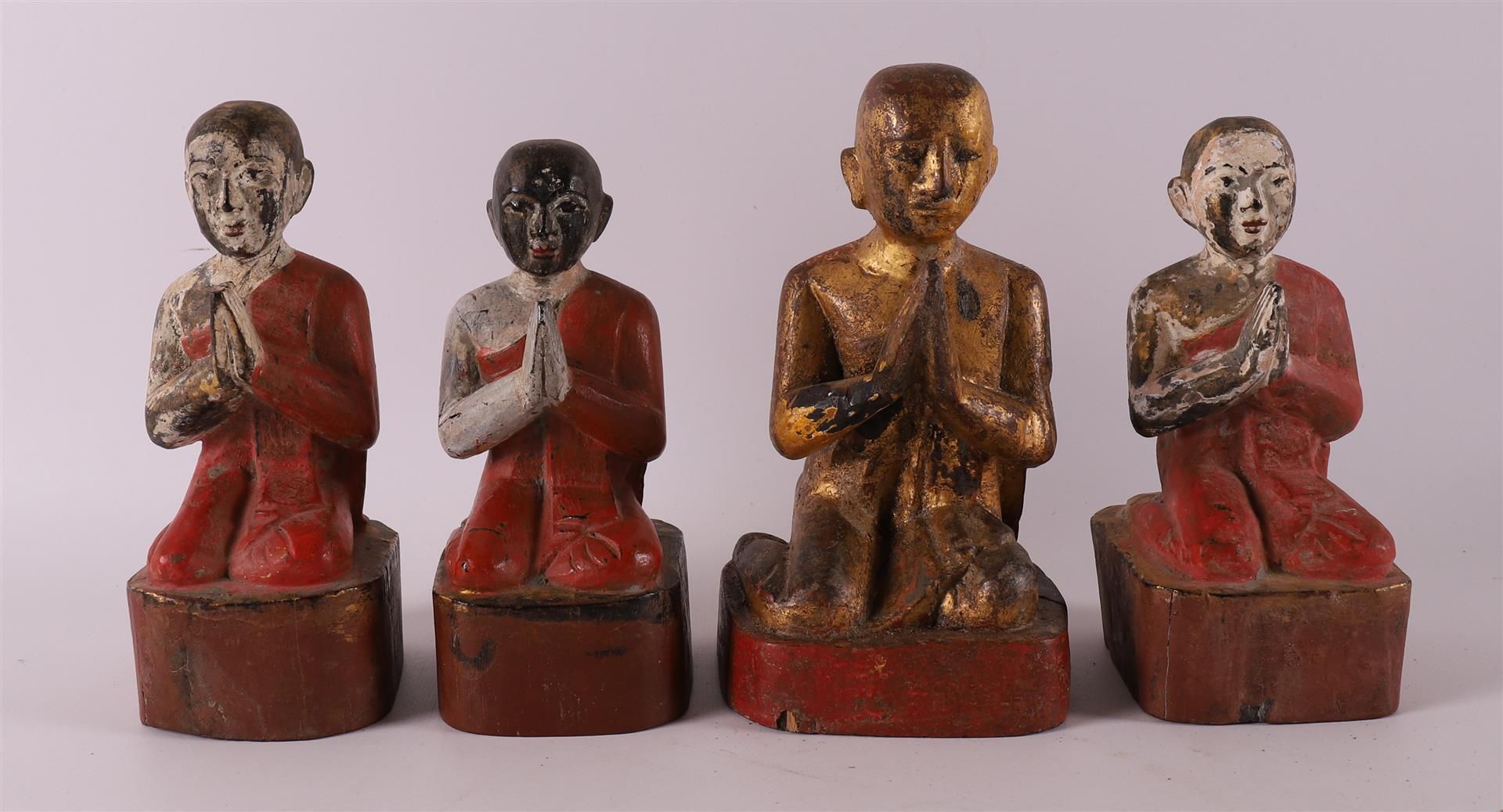 Four carved wooden Burmese Buddhist monks, 19th/20th century.