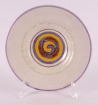 A round glazed earthenware dish, 1923-1930.