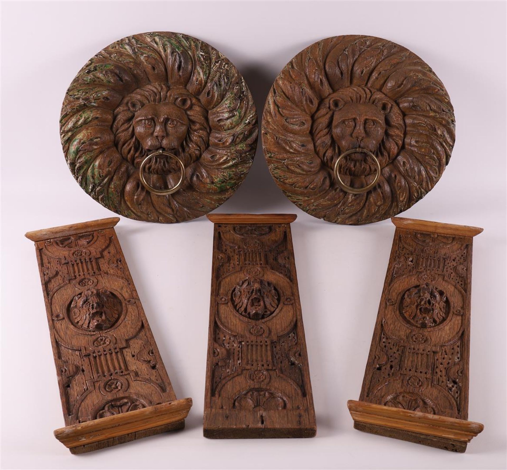 Two carved wooden rosettes of ringed lion heads, 18th century