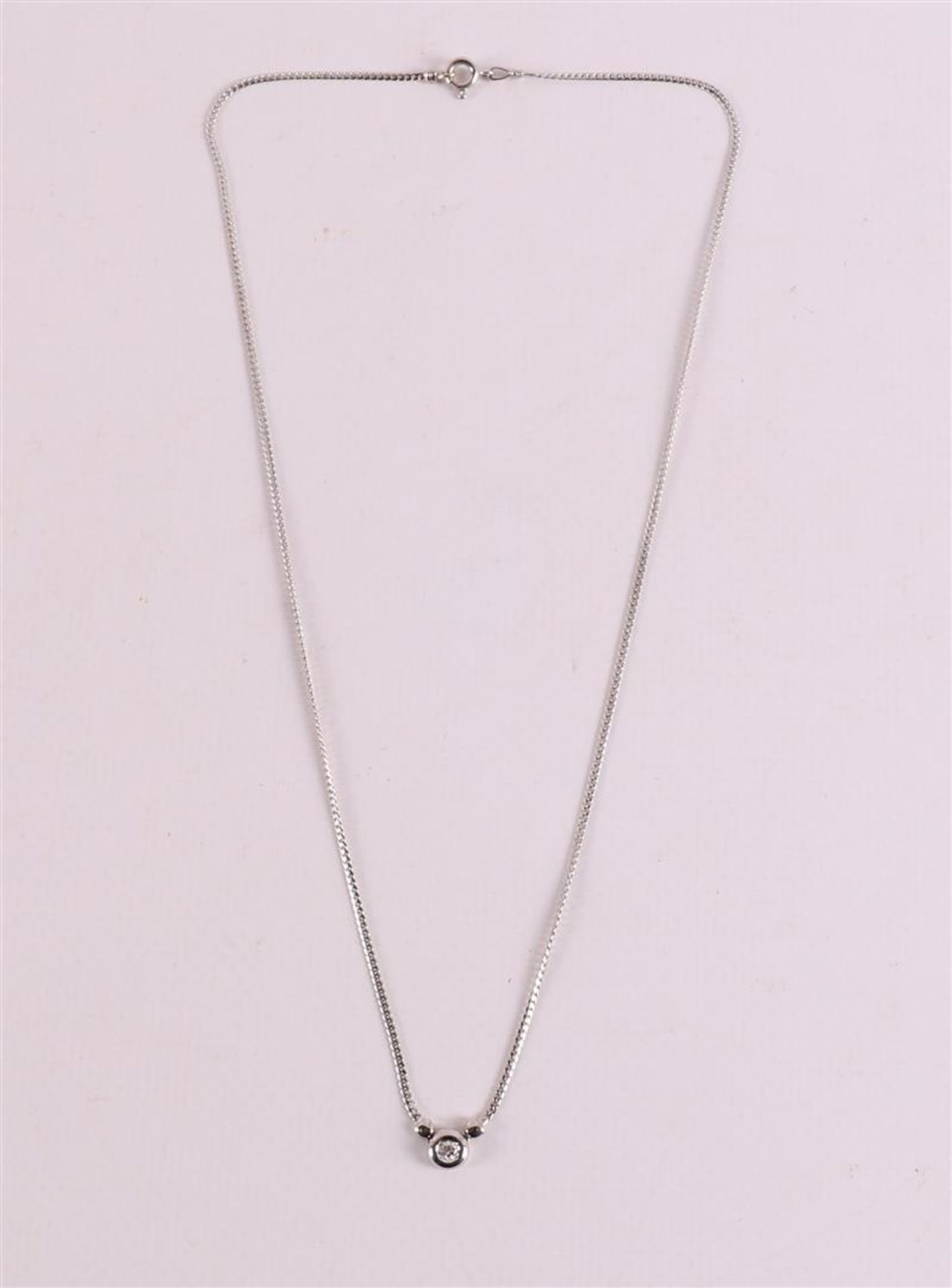 An 18 kt white gold necklace with a brilliant cut diamond.