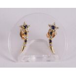 A pair of 18 kt gold stud earrings with blue sapphires and zirconias