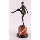 A brown patinated bronze Art Deco sculpture of a dancer with a skirt,