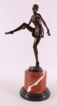 A brown patinated bronze Art Deco sculpture of a dancer with a skirt,