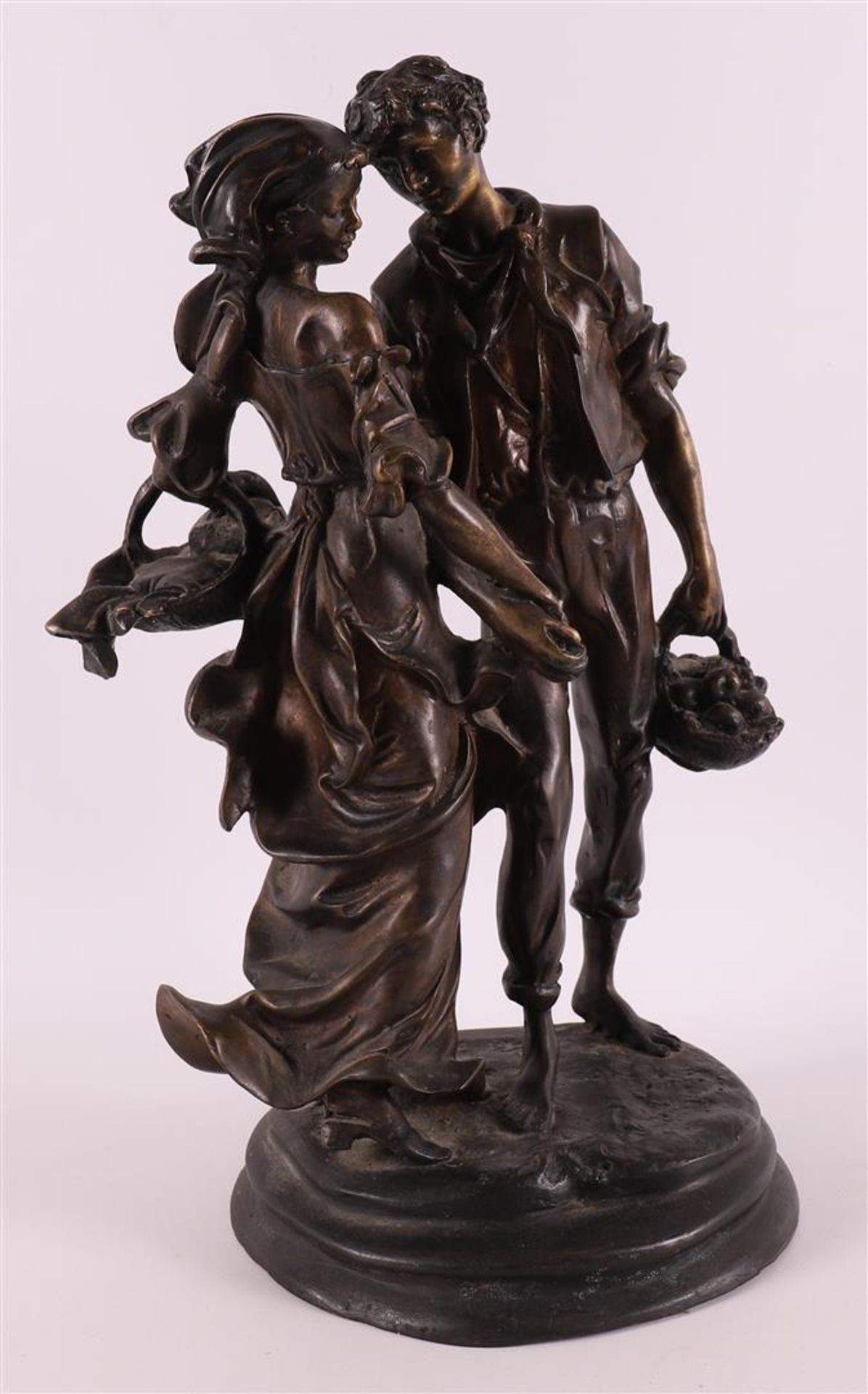 A brown patinated bronze sculpture of a man and woman, based on an antique examp