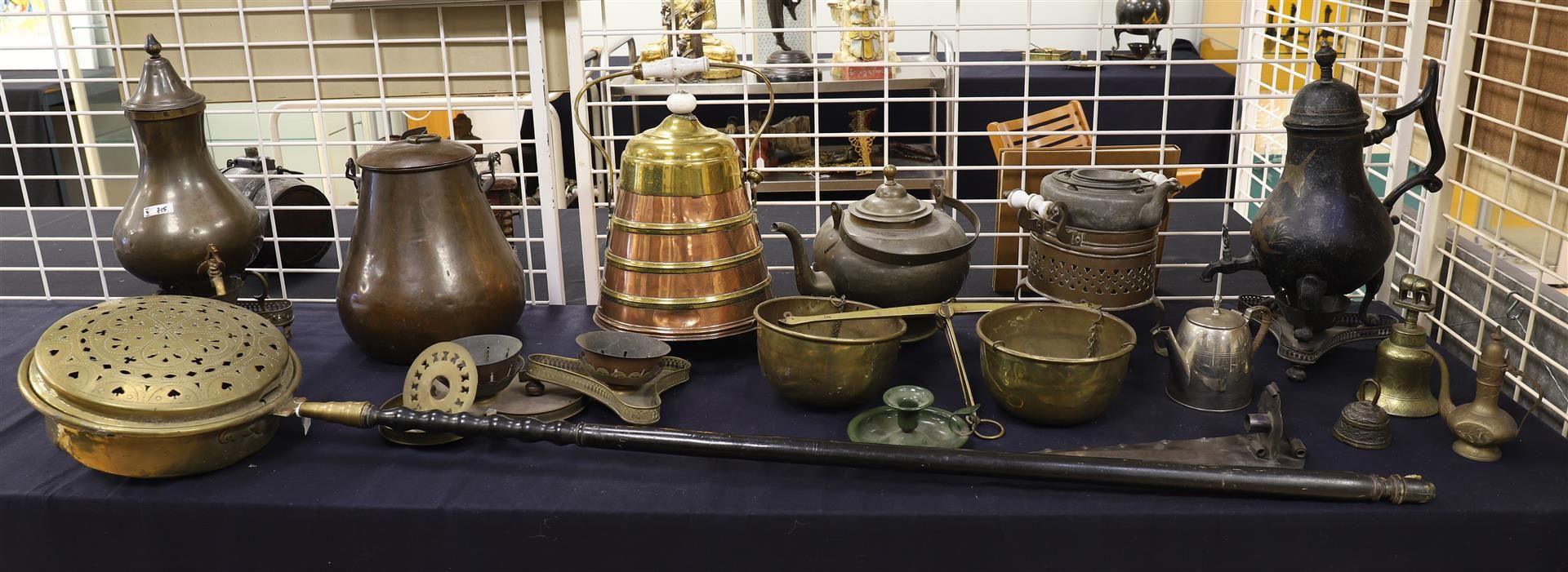 A brass bedpan on a turned wooden ebonised handle, 19th century