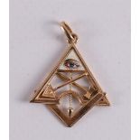 A gold pendant with symbols of Freemasonry.