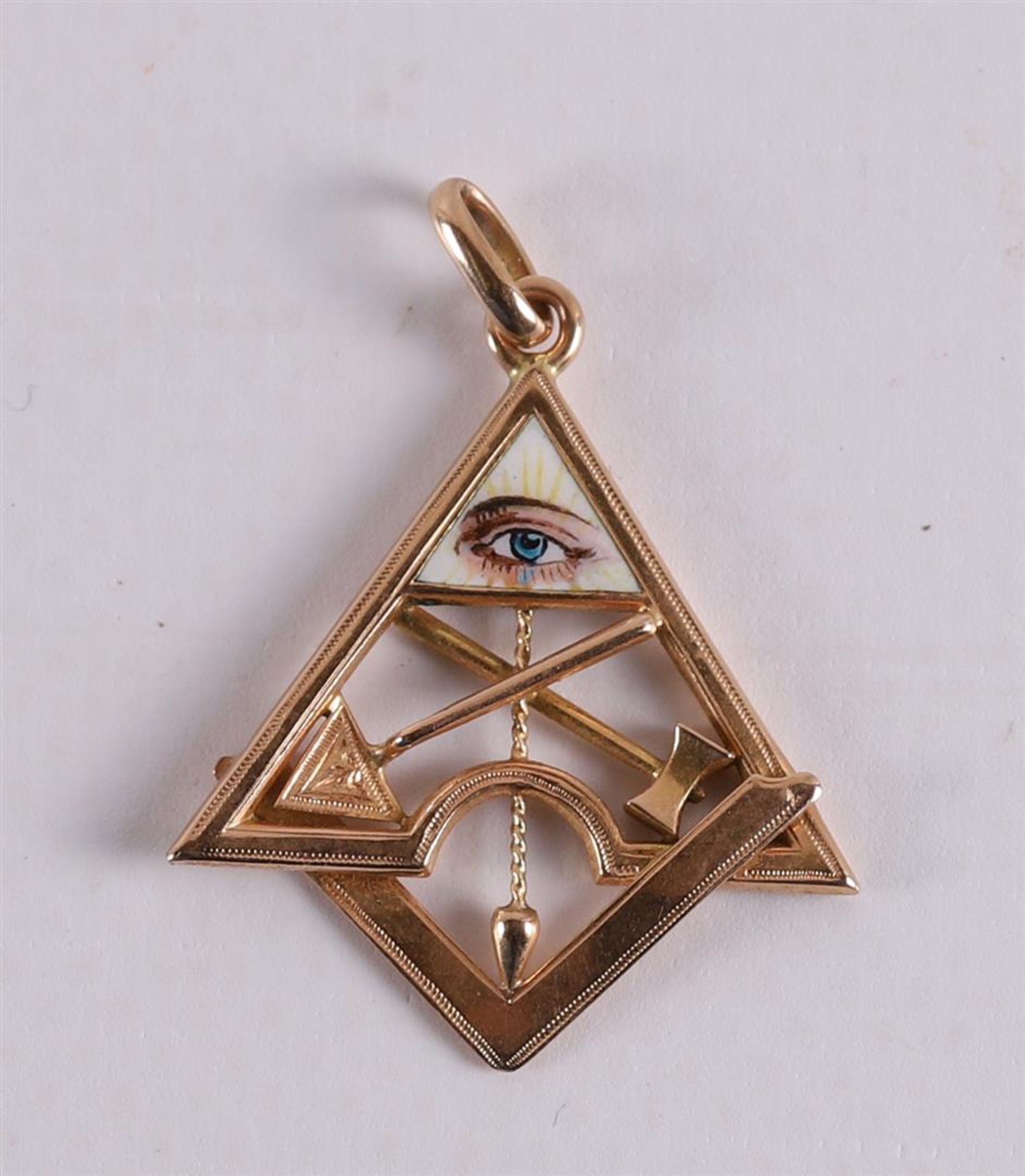 A gold pendant with symbols of Freemasonry.