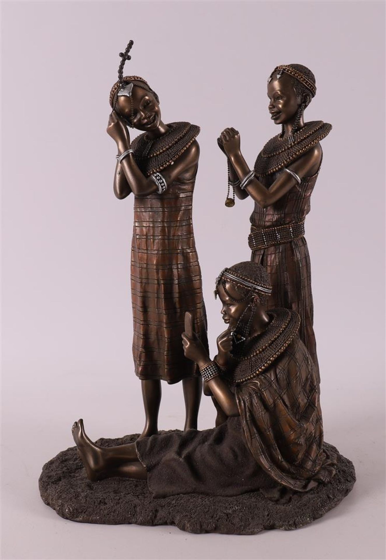 A bronze sculpture group 'Tayari Finischin Touches', reproduction, Africa.
