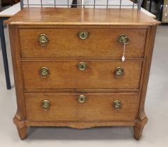 An oak three-drawer chest of drawers with brass ring fittings, early 19th centur