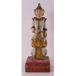 A carved polychromed wooden man in traditional clothing, Burma, 20th century