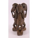 A carved sculpture 'Hear-See-Silence', Africa, 2nd half of the 20th century.