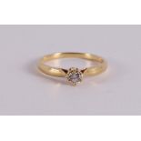 An 18 kt gold solitaire ring with a brilliant .
