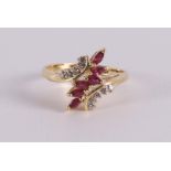 An 18 kt gold fantasy ring with 6 marquise cut rubies