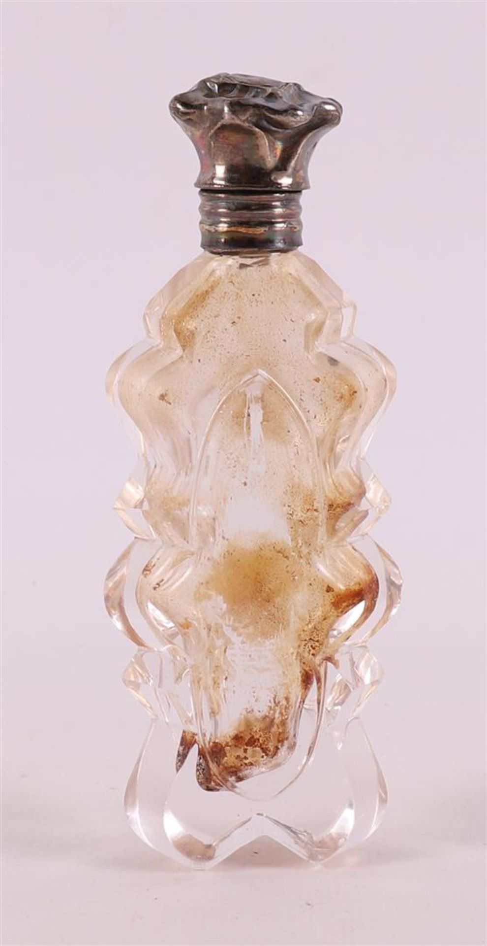 A crystal odeur bottle with silver flip cap and frame, including stopper,