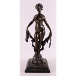 A brown patinated bronze sculpture of a female nude on tortoiseshell, 21st centu
