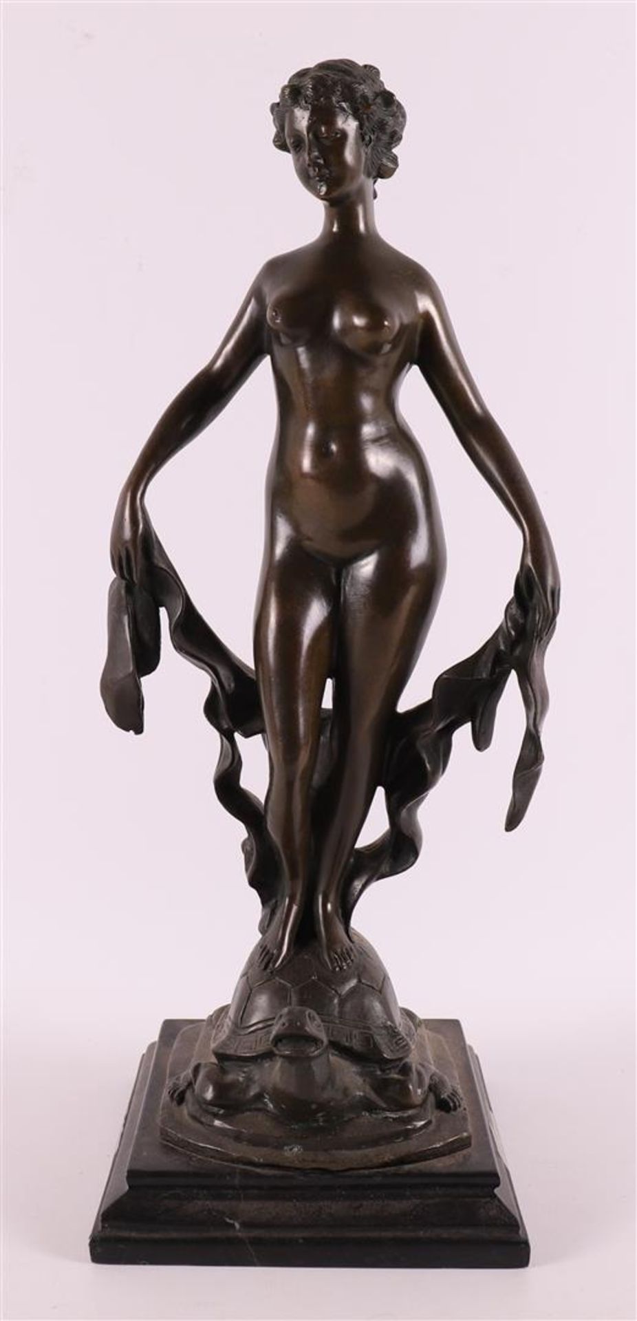 A brown patinated bronze sculpture of a female nude on tortoiseshell, 21st centu